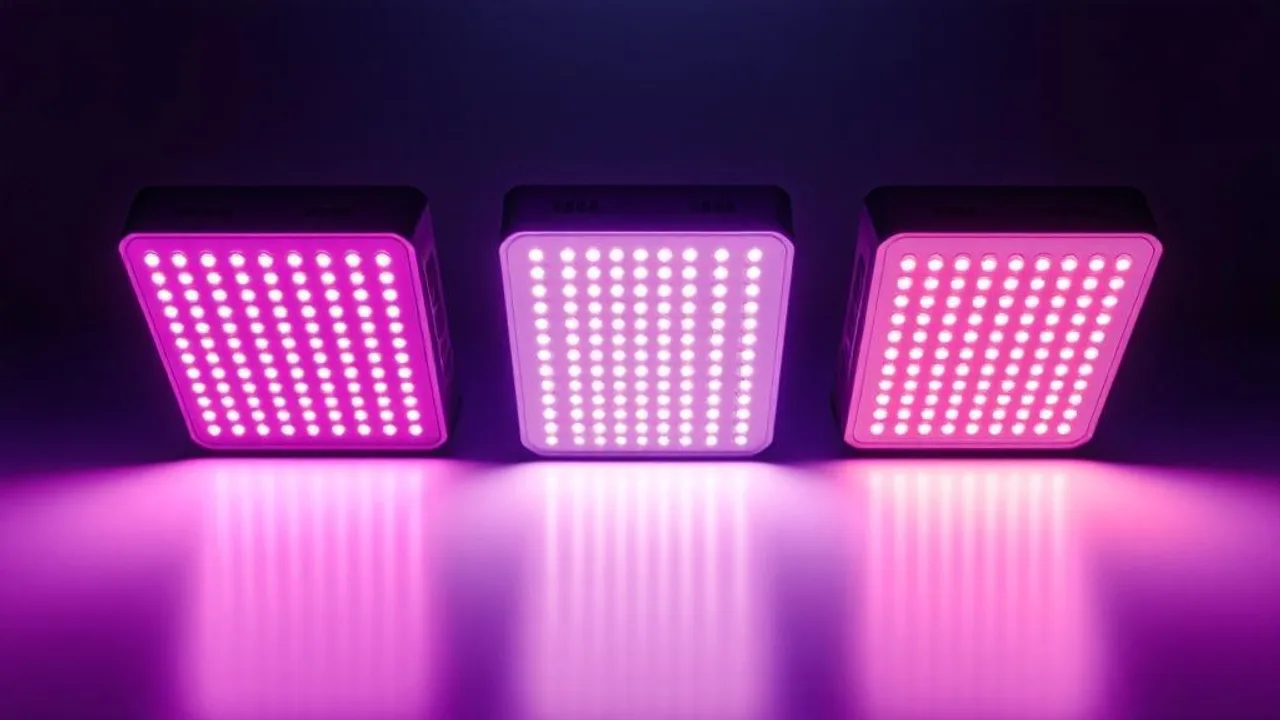 Three grow lights casting distinct colored beams—purple-pink LED, warm-white panel, and orange-yellow HPS—onto a white surface in a dark stu